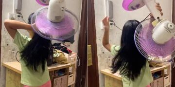 Girl Dries Hair With Fan